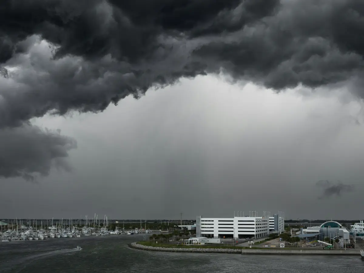 A dark storm front rolling in over a waterfront town